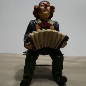 CLOWN porcelain sitting on bench playing accordion